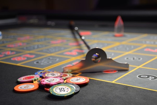 A picture showing some poker chips on a poker table