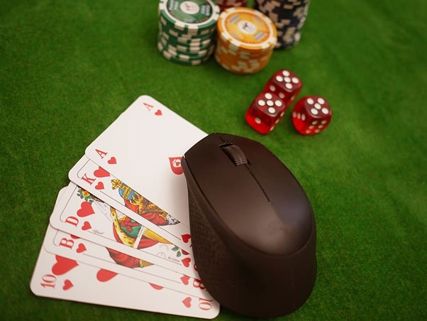 A picture showing a royal flush, with 3 dice and some poker chips in the background